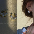 Four small pearl earrings