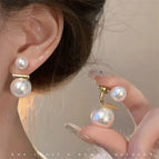 84# pearl two wearing earrings